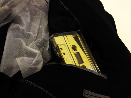 A close up of the dinner jacket showing the gold cassette in the pocket.